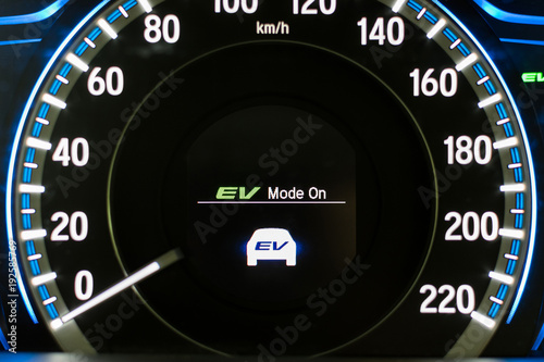 EV- Electrical vehicle mode turned on on hybrid car screen in front of steering wheel for green power fuel transportation technology, environmental eco- friendly, and saving energy concept