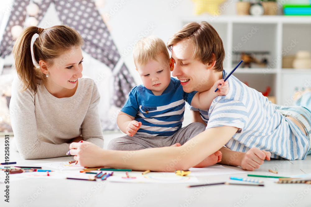 children's creativity. happy family mother father and son draw together children's creativity. happy family mother father and son draw together