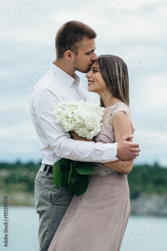 The happinest  couple in love embracing near river photo