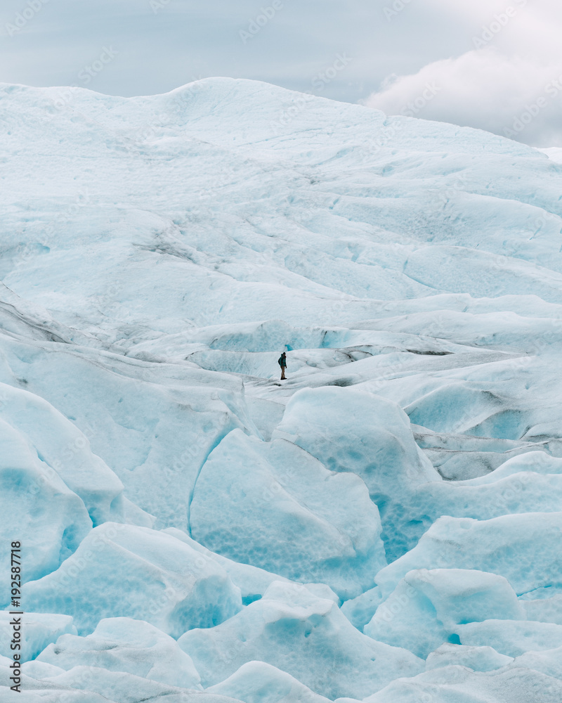 Tourist standing on snowy hill Tourist standing on snowy hill