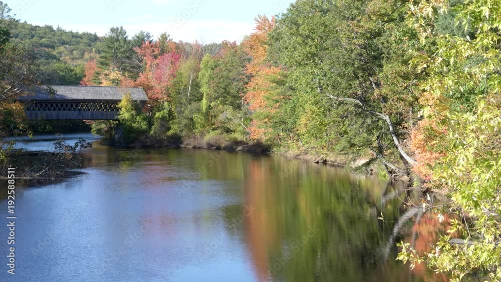 fall colors around the henniker covered bridge and the contoocook river in new hampshire, usa
