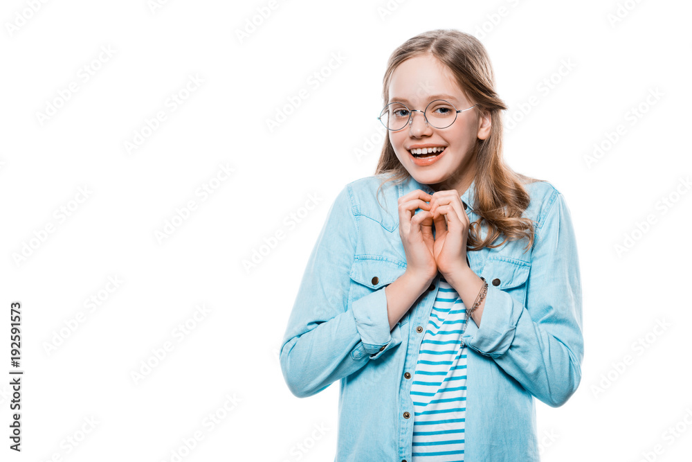 happy girl in eyeglasses showing hand heart symbol and smiling at camera isolated on white happy girl in eyeglasses showing hand heart symbol and smiling at camera isolated on white