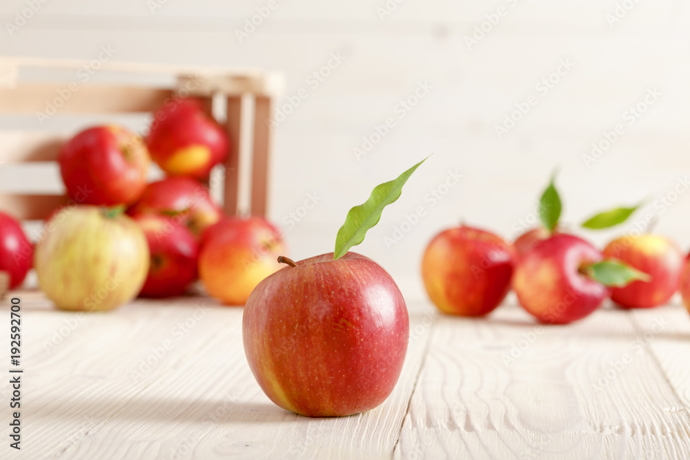 Red apples in a light wooden box Red apples in a light wooden box