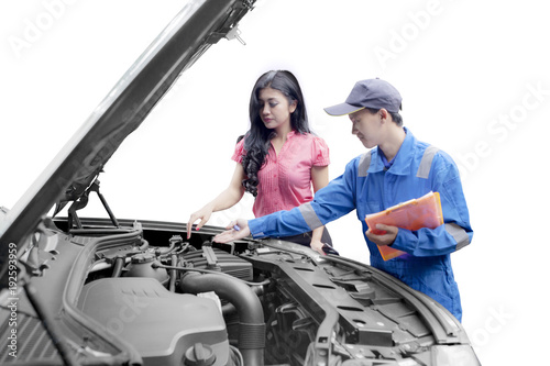 Mechanic helping a customer fixing a car
