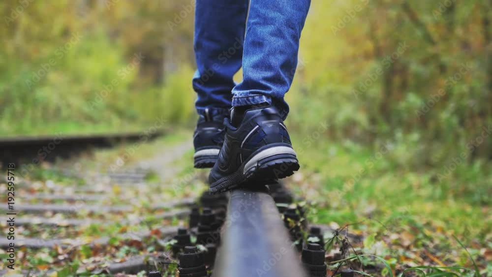 Boy walks along railway in autumn park. 3840x2160 Boy walks along railway in autumn park. 3840x2160