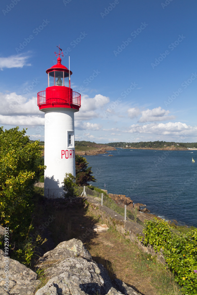 Port Manech Lighthouse against blue sky.