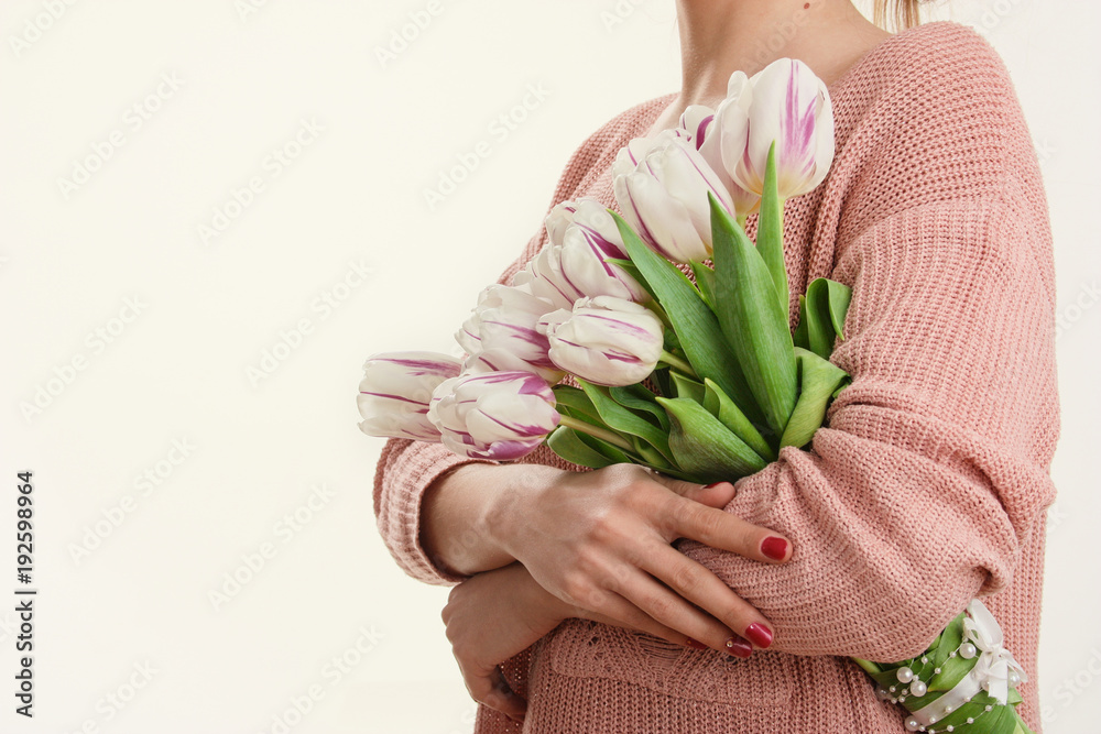 tender spring tulips in gentle female hands.