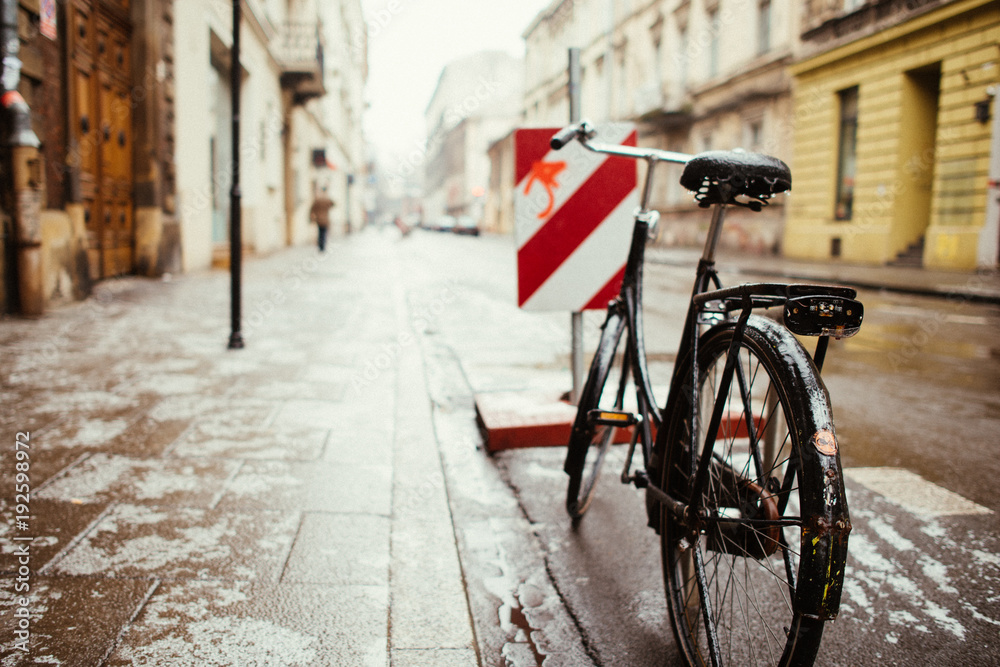 Old city black bicycle standing on the street Old city black bicycle standing on the street