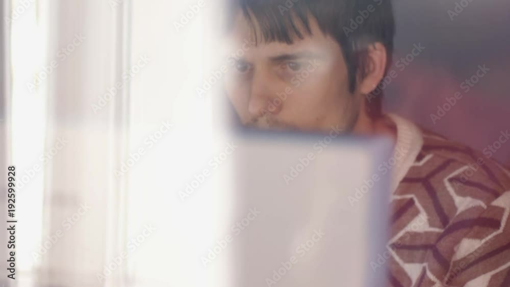 Close-up view through the window on handsome businessman working on a computer. 3840x2160 Close-up view through the window on handsome businessman working on a computer. 3840x2160