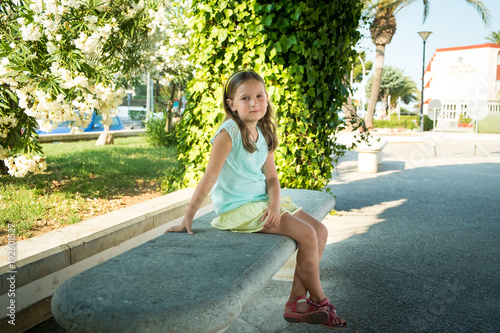 Portrait of a small girl in a summer park