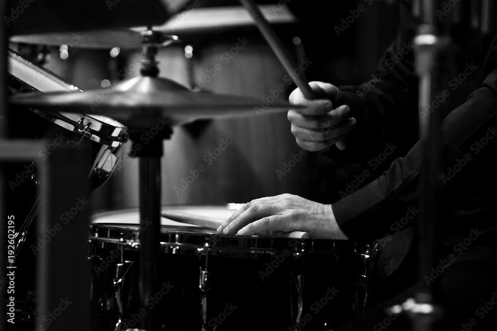 Naklejka premium Human hands playing the drum kit in black and white