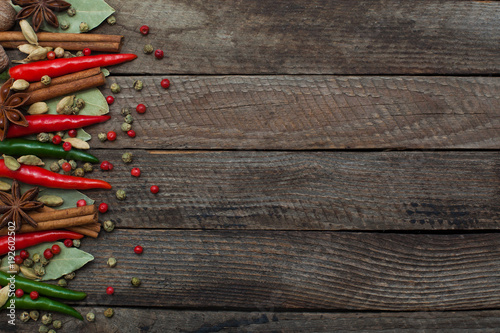 Different spices on a wooden surface