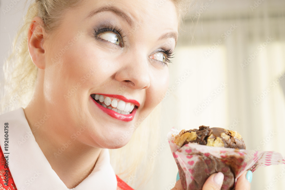 Attractive woman holds cake in hand