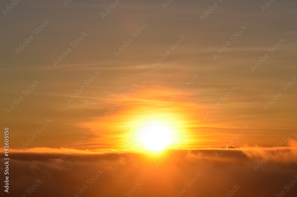 Sunrise over the cloud, first light of a new day when a sun start to emerge over the cloud in the early morning, abstract background, sunrise background,  tranquil background,