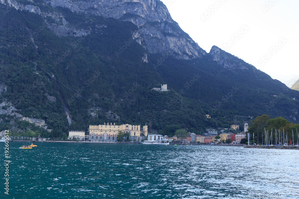 Riva del Garda town panorama with marina at Lake Garda and mountains, Italy