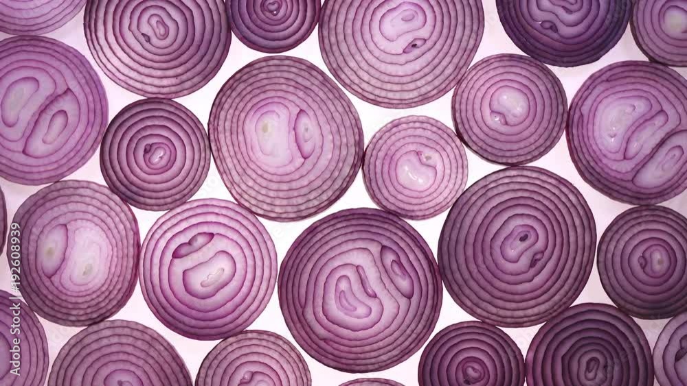 Sliced red onion rotation on white background in 4K. Top view.
