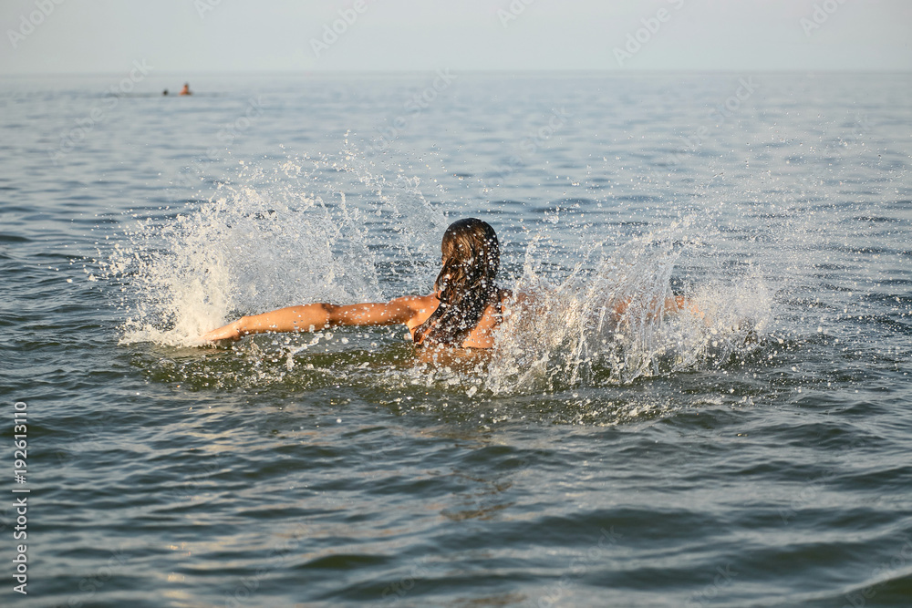 Spray with water. Girl having fun bathing in the sea. Spray with water. Girl having fun bathing in the sea.