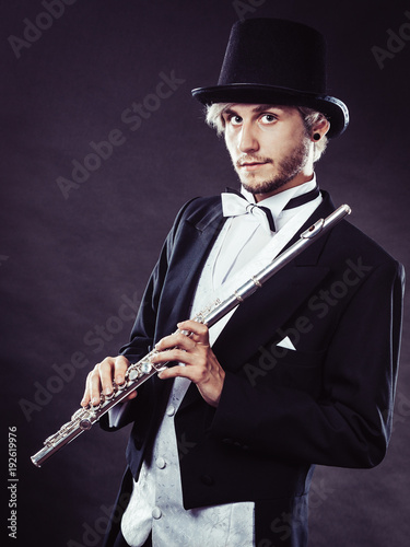 Elegantly dressed musician holding flute