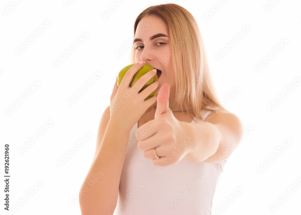 Pretty young girl with green apple, studio Pretty young girl with green apple, studio