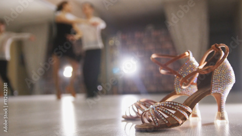 Konstfotografi Blurred professional man and woman dancing Latin dance in costumes in the Studio