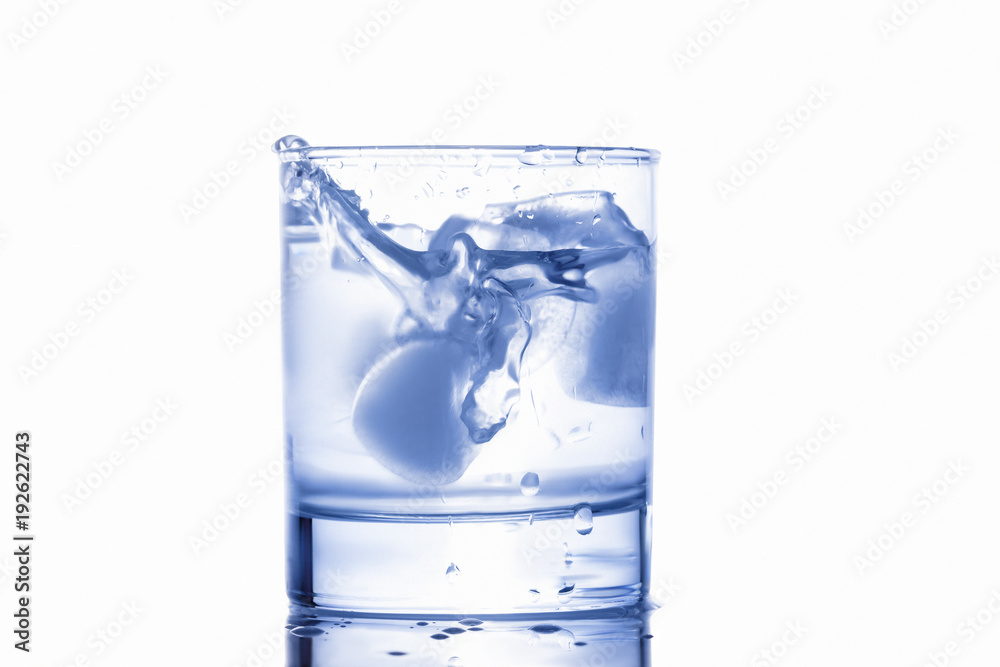 blue water splashing out of a glass with drops blue water splashing out of a glass with drops