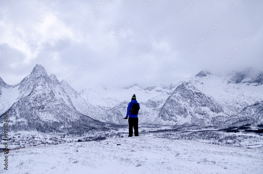 Person Looking Out over Snow Covered Landscape