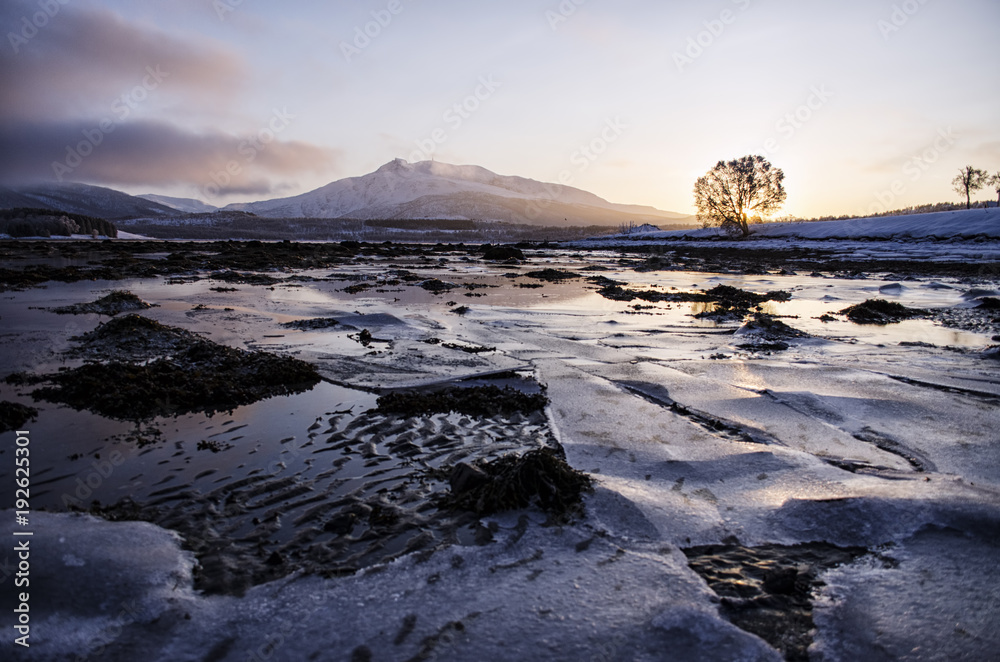 Sunset Behind Mountain over Ice Lake