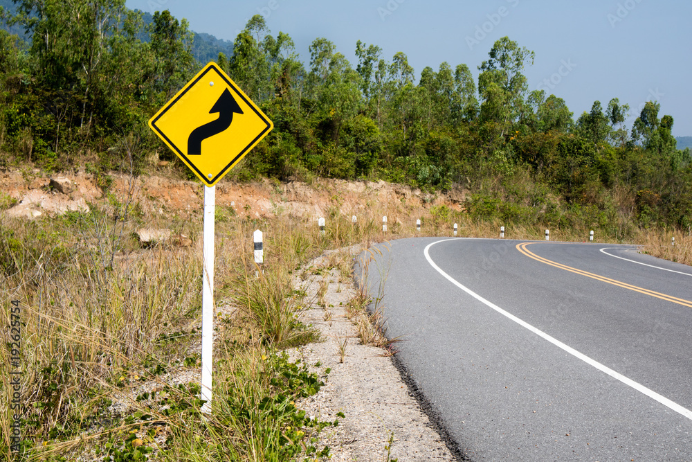 Traffic sign on a road bend Traffic sign on a road bend