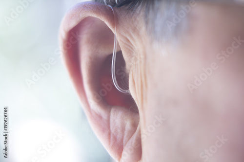 Hearing aid in ear Fototapete