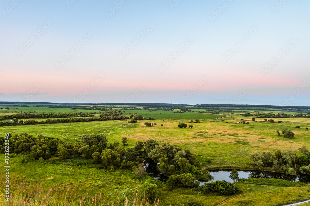 Obraz premium View of green forest-steppe plain. River Koren (Root) valley, typical landscape of Belgorod region, Russia. Evening time.