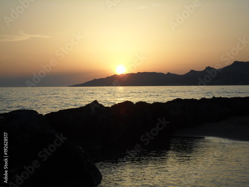 Il sole tramonta sul golfo di Licata photo