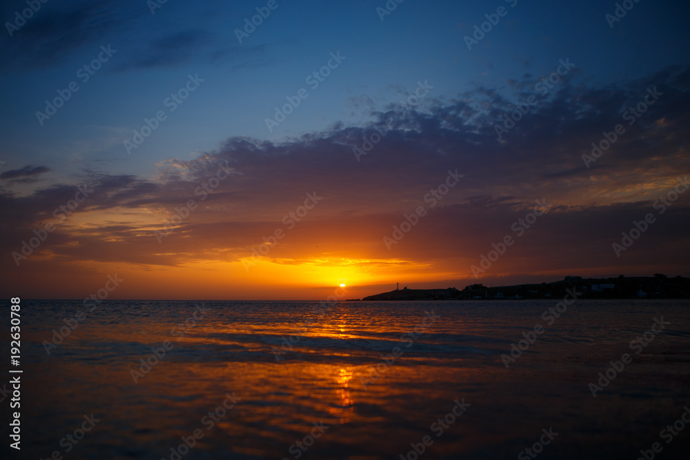 sunset over the sea. sunset over the sea.Sunset / sunrise with clouds, light rays and other atmospheric effect. sunset over the sea, calm . the concept of tranquility. rest and travel