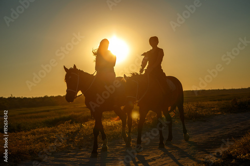 Young girl on horseback at sunset