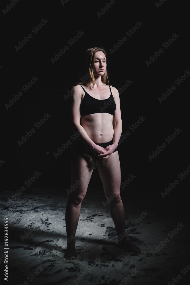 Obraz premium Girl dansing with flour on black background