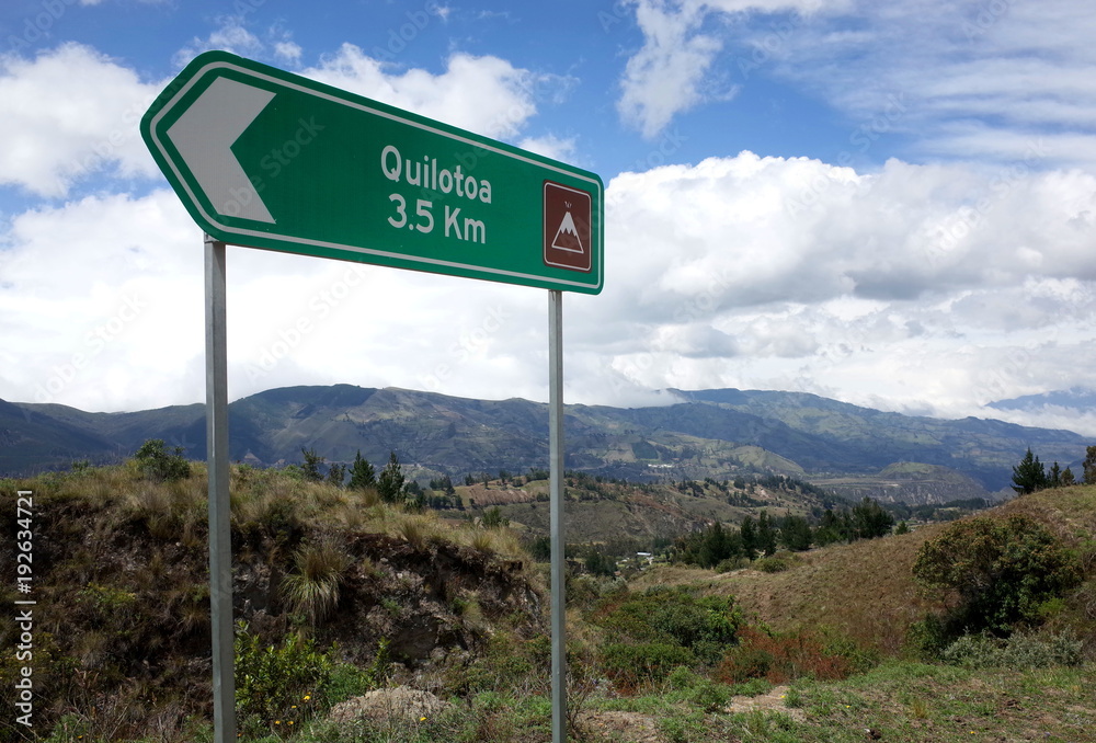 A sign marks the way of the Quilotoa Loop hike in the Ecuadorian Andes A sign marks the way of the Quilotoa Loop hike in the Ecuadorian Andes