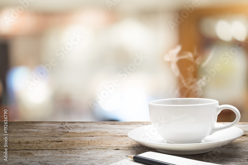 Wooden table with blur background of coffee cafe.