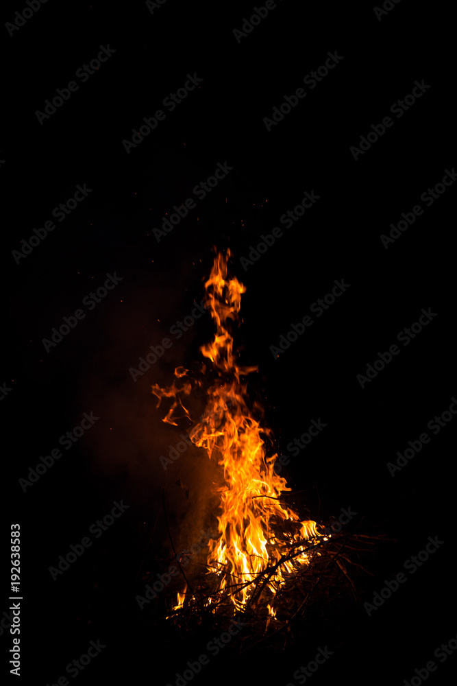 Fire burning dry vegetation at night