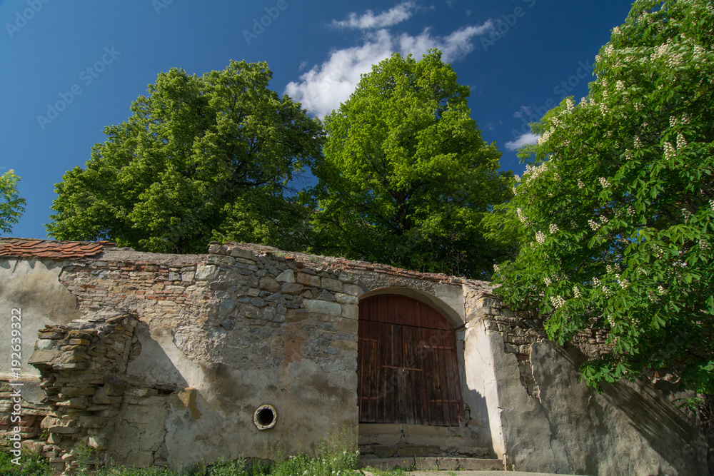 Stone wall of a fortified church in Transylvania, in Spring time