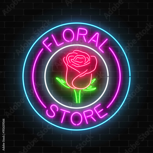 Glowing neon sign of floral store in round frames on dark brick wall background. Design of flower shop signboard.