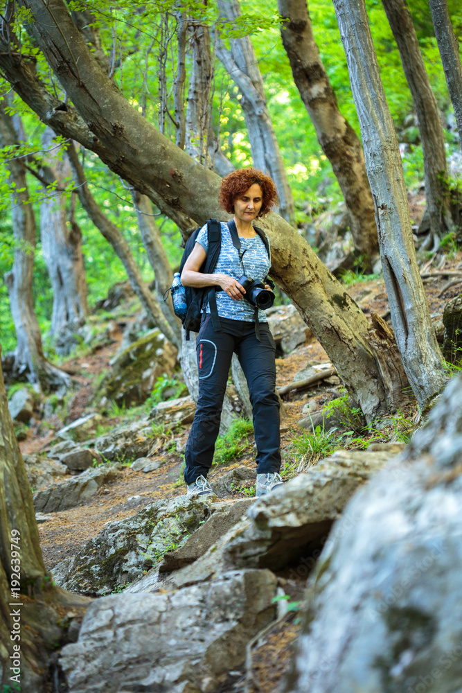 Naklejka premium Tourist with camera and backpack