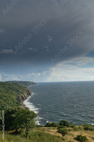 Heavy, rainy dark clouds on the coast © Mateusz