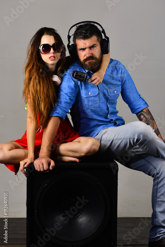 Music fans with serious faces enjoy music. Couple in love
