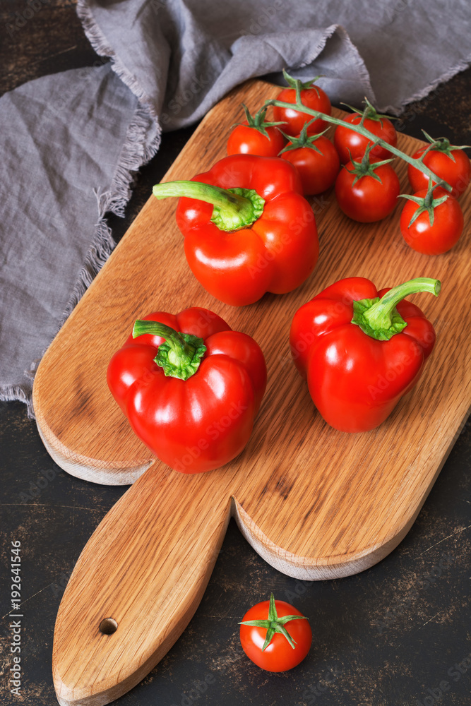 Sweet red pepper with cherry tomatoes on a cutting board. selective focus. Sweet red pepper with cherry tomatoes on a cutting board. selective focus.