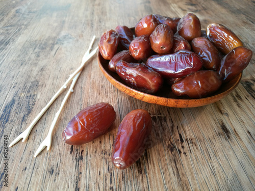 Dates in a wooden plate and two forks
