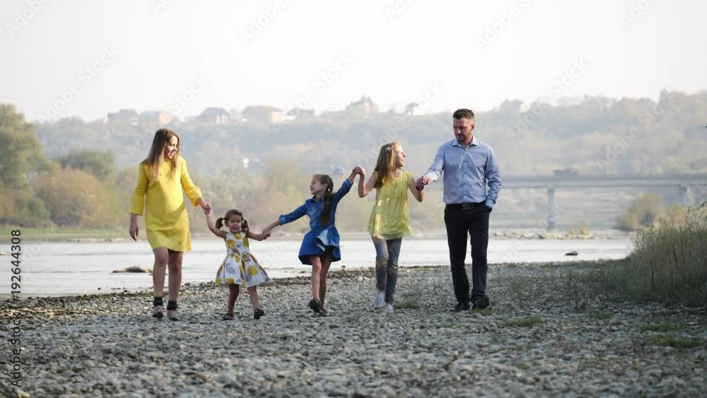 Happy young family walking by the river. Happy young family walking by the river.