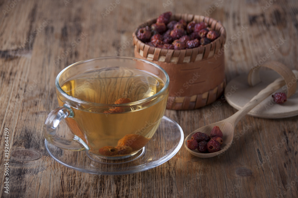 Rosehip tea on an old wooden table Rosehip tea on an old wooden table