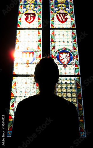 Girl looking at the colorful of windows of an old castle in Prague, Czech Republic. photo