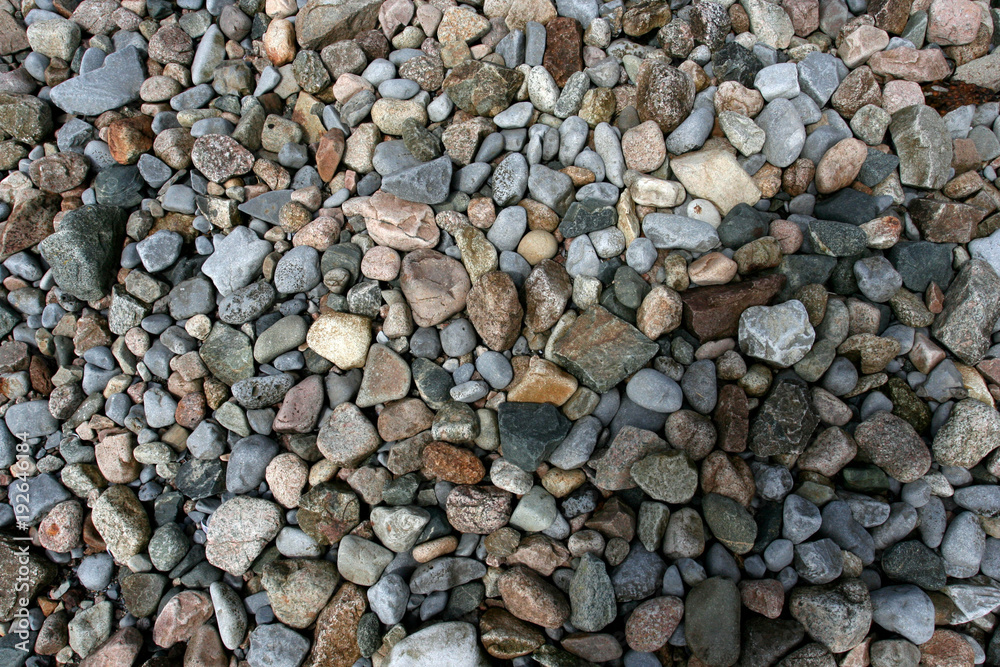 Many small multicolor stones on a sea coast. Many small multicolor stones on a sea coast.