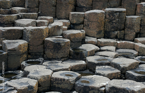 Brown basaltic columns and tops of basaltic prisms (fragment of the Giant’s Causeway in Northern Ireland)