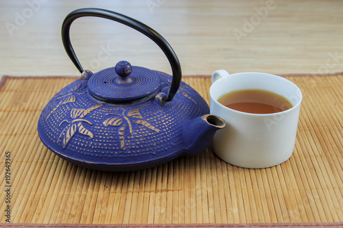Blue Chinese cast iron teapot. The process of brewing tea.